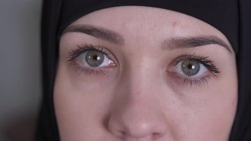 Extreme Close-up of Hazel Eyes of Sad Muslim Woman in Traditional Black Hijab. Portrait of Beautiful