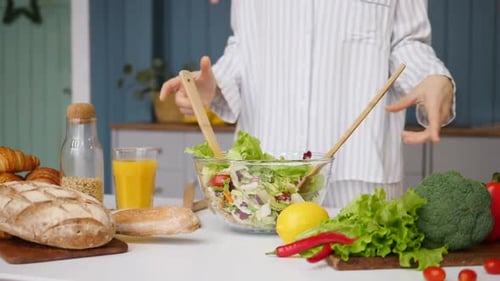 Close-Up Of Woman Hands Preparing Salad On The Kitchen. Healthy Diet Concept. Slow Motion.