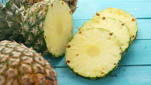 Fresh Pineapple Slices on Blue Wooden Surface