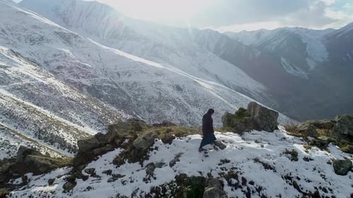 Woman Hiking on Snowy Hill and Mountains Forests