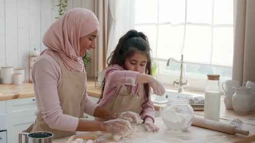 Arabic Mother And Daughter Kneading Dough Adding Flour Baking Indoor