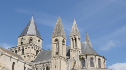 The Mens Abbey by the day William the Conqueror legacy against blue sky 4K 3840X2160 slow tilt Ultra