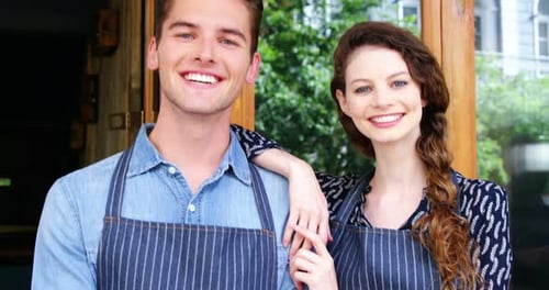 Waiter and waitresses standing at the entrance of cafe
