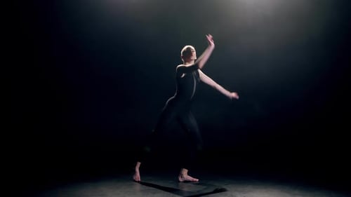 Elegant Dancer in Black Performing Modern Dance