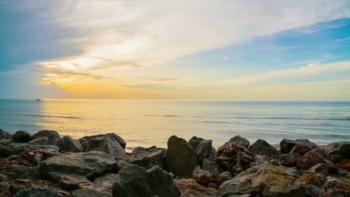 Sunrise Over a Rocky Beach Ocean Horizon