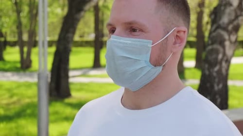 Man Wearing Face Mask Outside in Park
