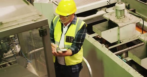Engineer writing on clipboard