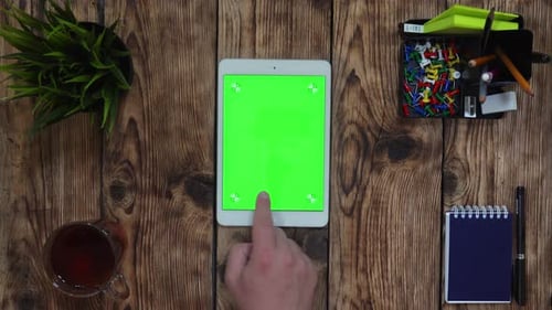 A Man's Finger Scrolling on the Green Touchscreen