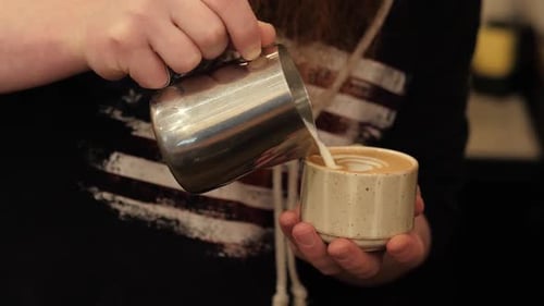 Barista Pouring Steamed Milk for Latte Art