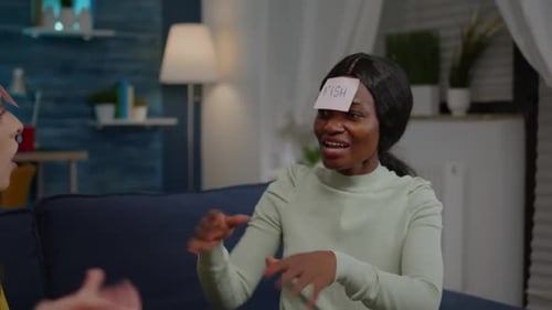 Mixed Race Friends Playing Board Game Using Sticky Notes Spending Time Together