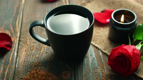 Dark Mug with Burning Candle and Red Rose