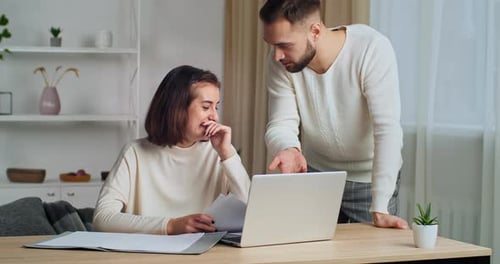 Happy Couple Working at Home with Laptop