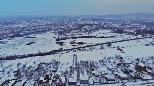 Village in snow covered houses in winter time view from the bird