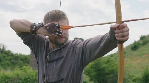 a Young Guy Shoots a Bow at a Target in Nature and Hits the Target the Arrow Pierces the Target for