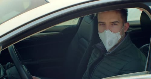 Man in Car Wearing Face Mask, Daytime