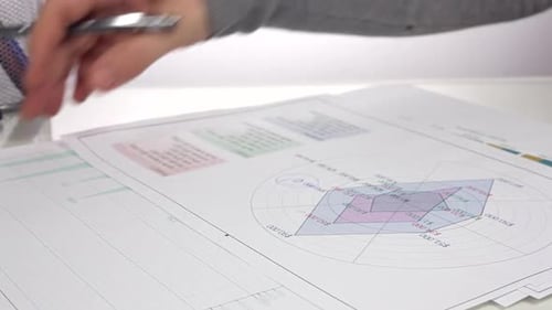Analyzing Charts, Pen Writing on Financial Data