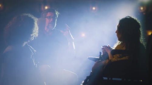 Actors Performing a Dramatic Scene on Stage at Night