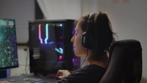 Woman Playing Computer Game with Headphones On