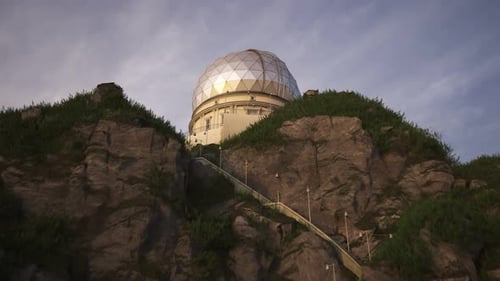 A modern astronomical observatory building on a steep rocky coast. 4KHD
