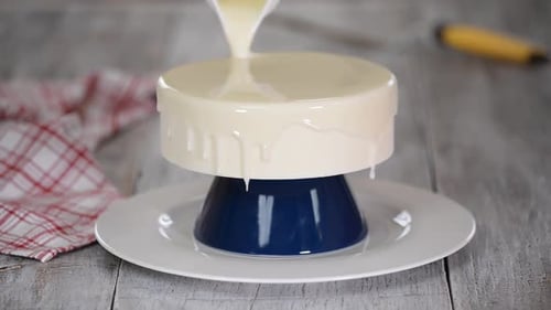 Cake Being Glazed with White Icing