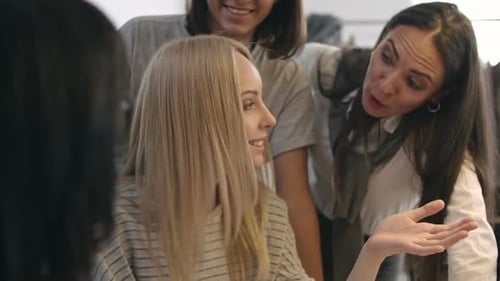 Designers Collaborating on Garment Design in Office