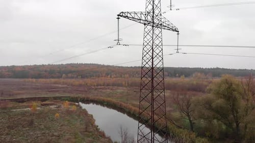 Transmission electricity steel pylon tower in forest. Electric tower lines. High voltage power pylon