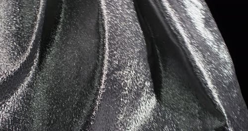 Glistening Silver Fabric Against a Dark Background