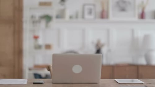 African Man Coming Back Opening Laptop in Office
