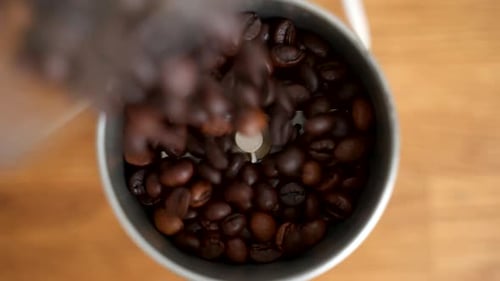 Coffee Beans Pouring into Grinder for Fresh Brew