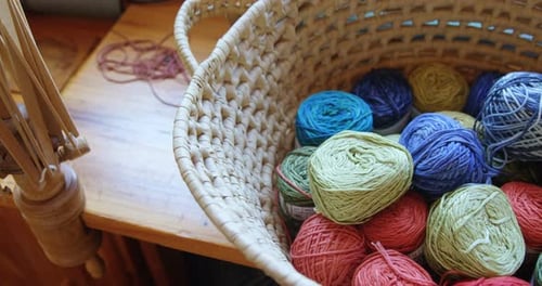 Bunches of different coloured woollen yarn kept in basket 4k