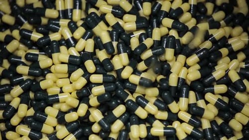 Tablets Falling Into Container