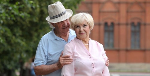 Charming Senior Couple Embracing Outdoors in Urban Setting