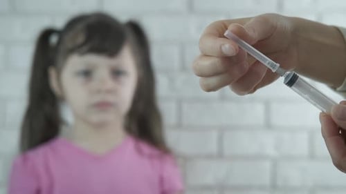 Scared Child Awaiting a Vaccine Injection