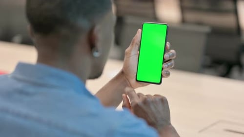 Man Using Smartphone with Green Chroma Key Screen