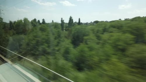 Scenery From Fast Moving Train on Sunny Day