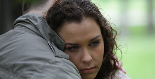 Affectionate Couple Embracing in a Green Outdoor Setting