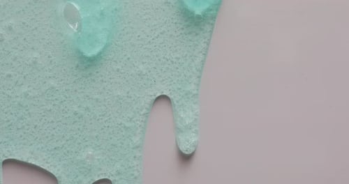 Light Blue Gel Texture Dripping on White Surface