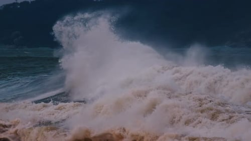 Big Wave with Foam and Dirt Breaks on the Shore During Strong Storm in the Atlantic Ocean