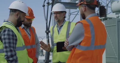 Foreman Explaining Data To Employees on Power Plant