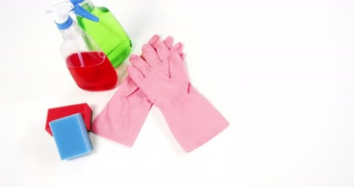 Cleaning Supplies with Gloves and Spray Bottles