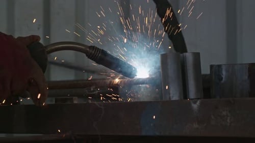 Slow motion of a welder welding construction steel frames