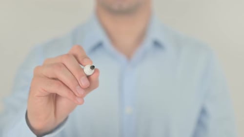 Man Writes the Word "Benefit" on Clear Surface