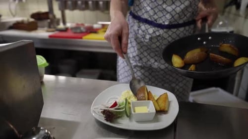 Plating Delicious Potato Wedges at Restaurant Kitchen