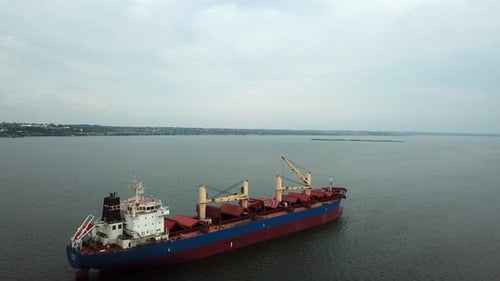Aerial view nternational cargo ship at industrial import-export port sailing