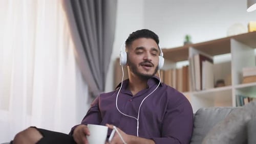 Man Relaxing at Home Listening to Music
