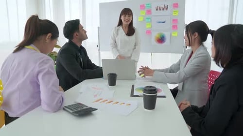 Business Team Receives Successful Presentation in Modern Office