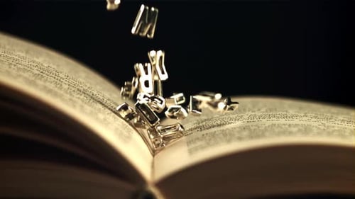 Metal Letters Falling onto Open Book Pages