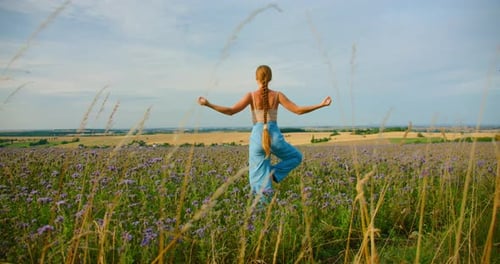Yoga at Sunset Happy Young Woman Practicing Yoga Tree Pose Stretching Health and Wellness