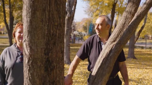 Loving Old Couple Walking Talking Outdoors in Park