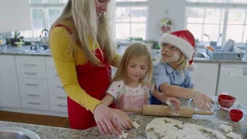 Family Baking Christmas Cookies Together in Kitchen